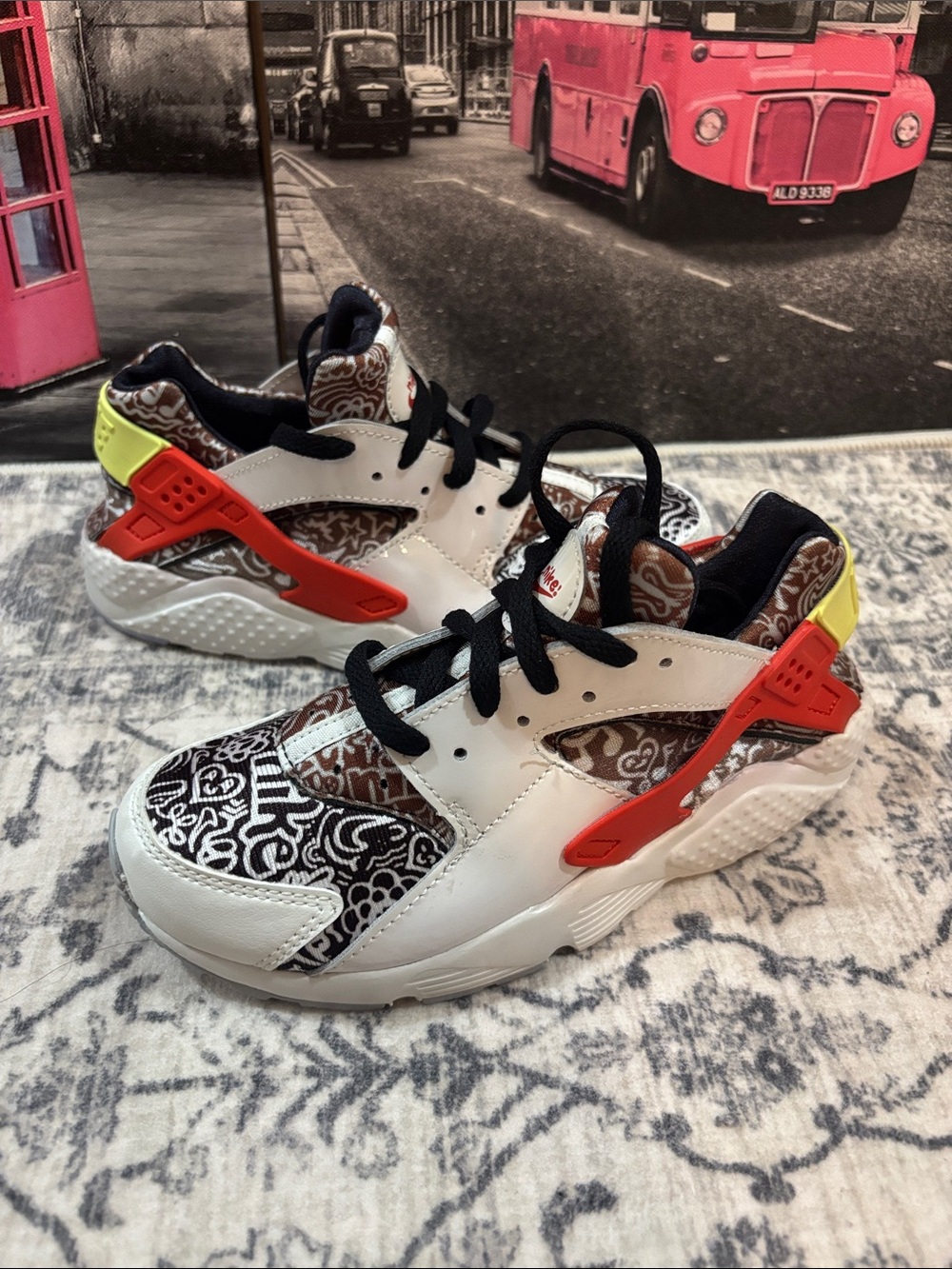 Nike Huarache Kids White Sneakers with Black Pattern, Orange & Yellow Accents